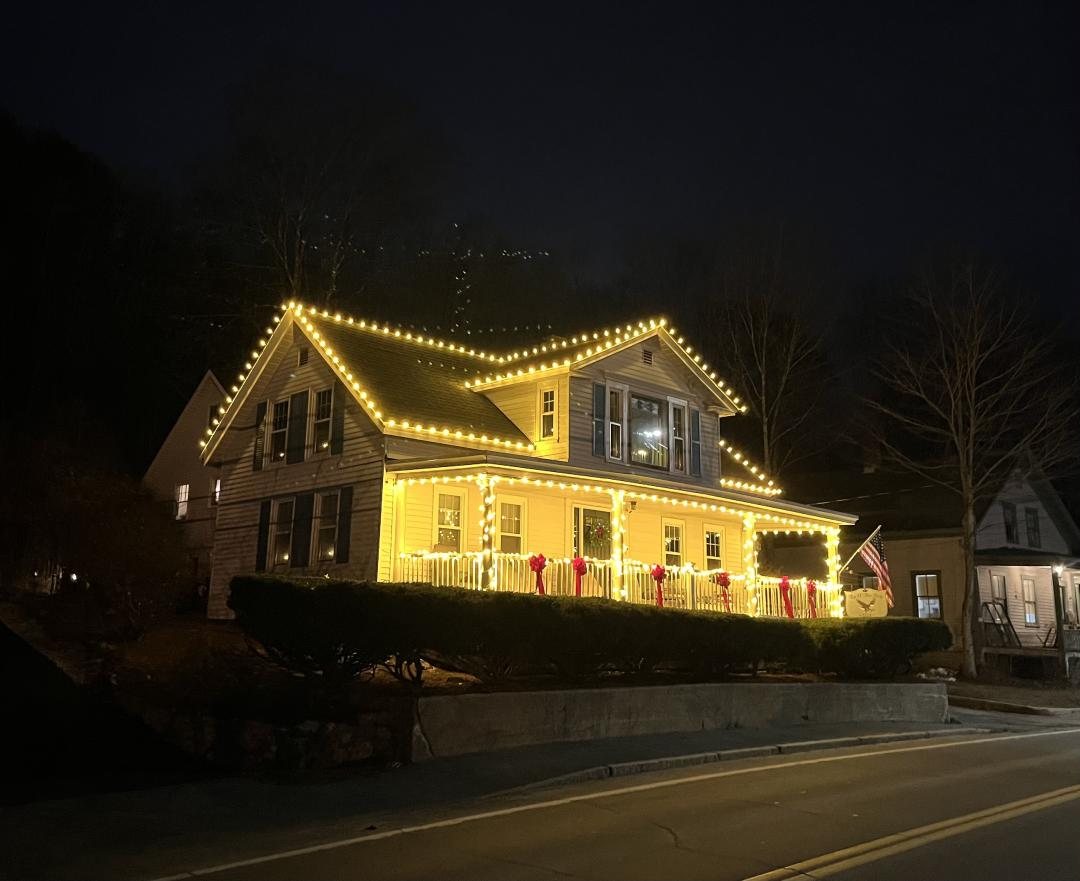 Full home Christmas light installation with roofline and porch lighting near Howell, MI